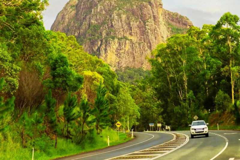 road with onw of the glasshouse mountains in the background