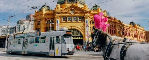 view of Spencer street station in Melbourne with a tram and horse in the background